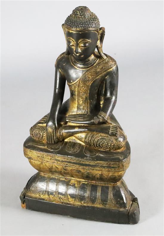 A large Thai gilt and black lacquered wood figure of Buddha Shakyamuni, 19th century, H. 64.5cm, lacking ushnisha